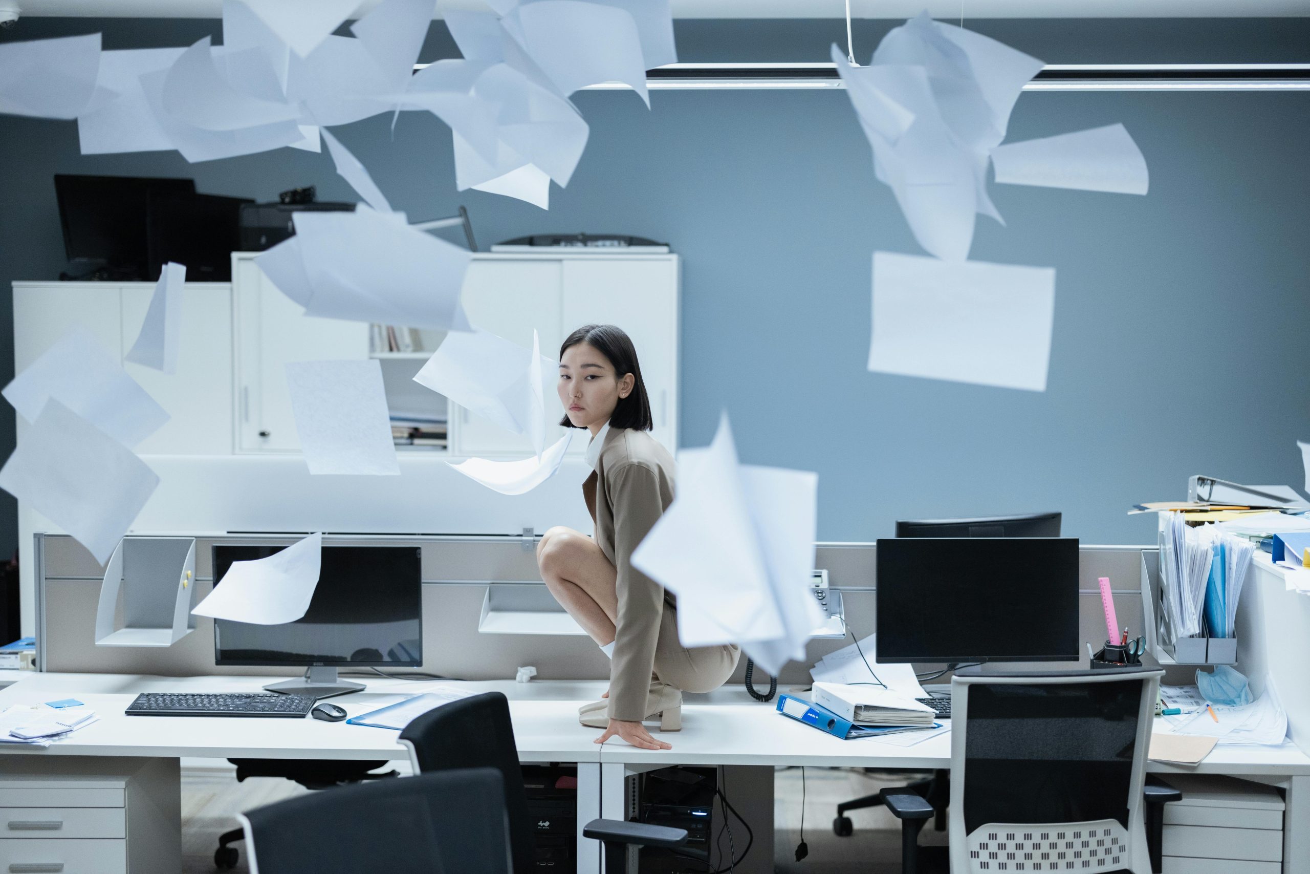 Woman on desk showing how Scheduled Shredding can prevent overwhelm